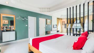 A modern hotel room with a large bed, a wardrobe, a vanity, and a window with curtains.
