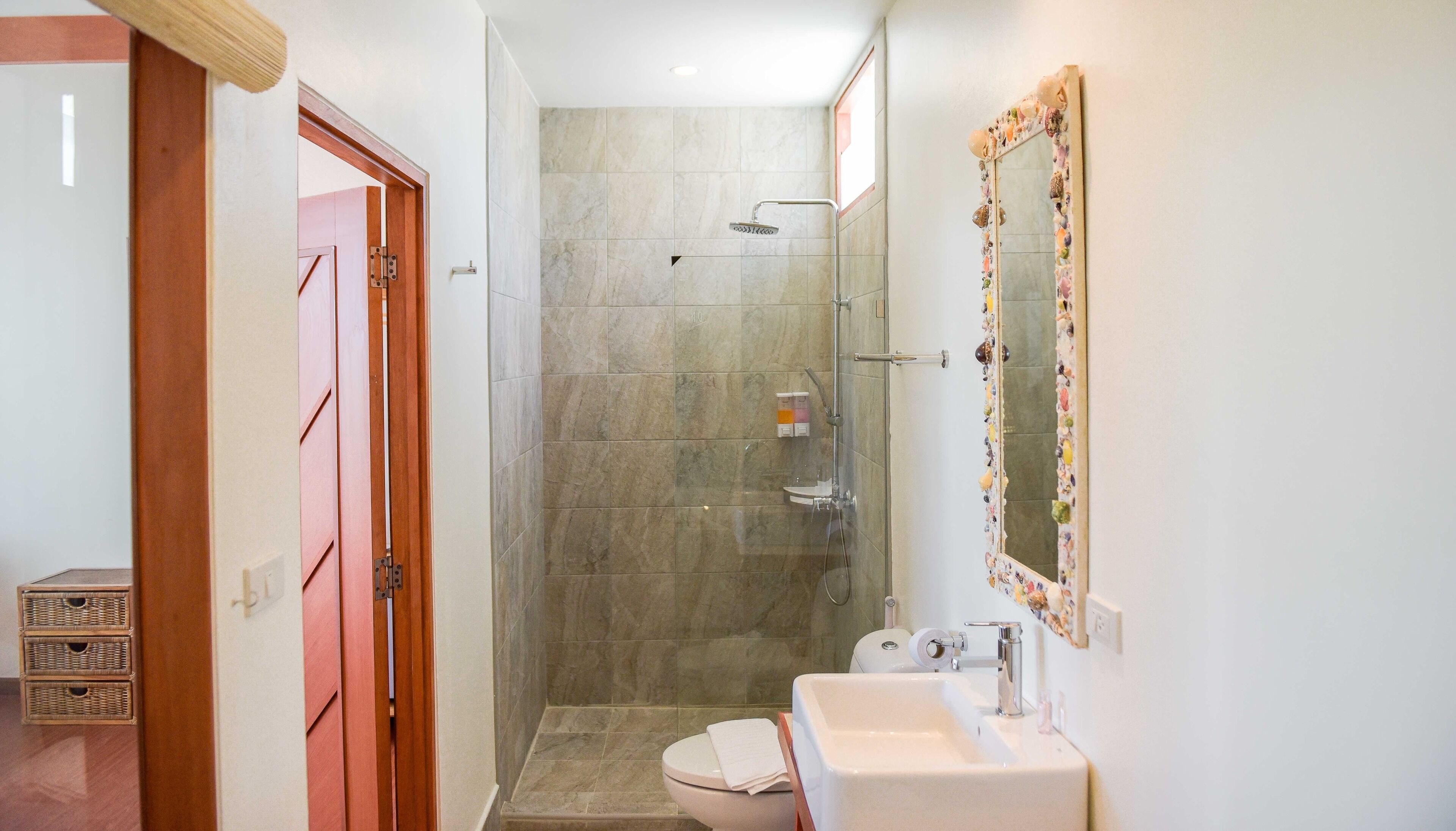 A bathroom with a shower, toilet, and sink.