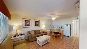 A compact living space with a sofa, a dining table, and a kitchenette. - Holmes Beach | Couples Gulf Coast Retreat | Pool + Beach (Holmes Beach)