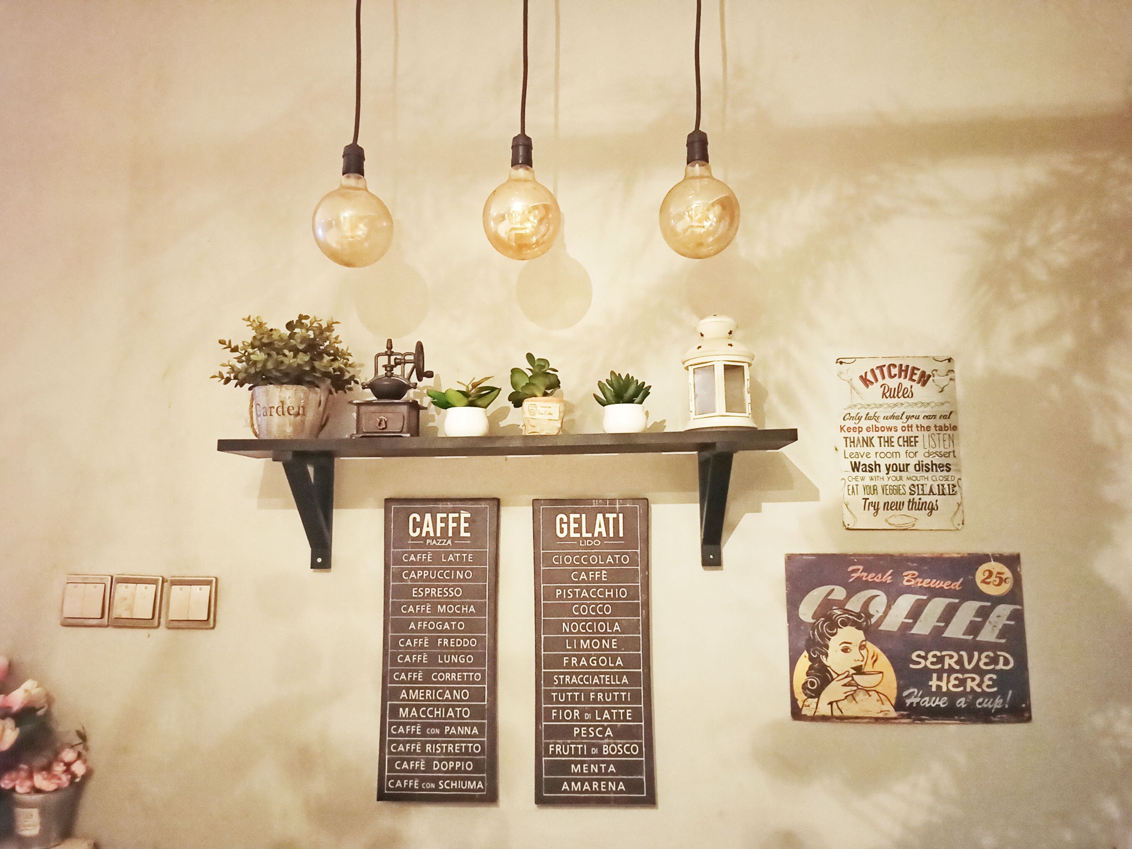 A wall with a coffee menu, a gelato menu, and a kitchen rules sign.