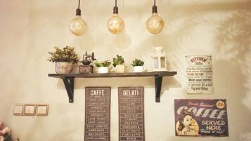 A wall with a coffee menu, a gelato menu, and a kitchen rules sign.
