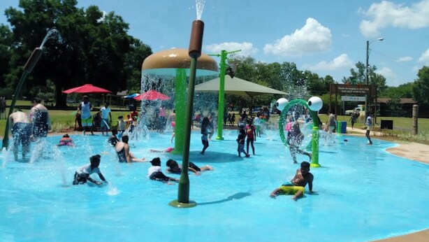 A water park with multiple water features and people enjoying the facilities.