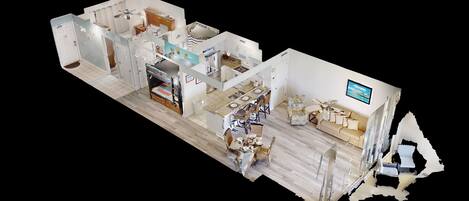 A 3D model of a hotel room with a kitchen, dining area, and living room.