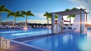 Guests can relax by the pool surrounded by lush gardens and a pergola with a shaded area.