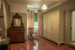 A room with a wooden dresser, a rocking chair, and a large white wardrobe. - La Casa di Eio Apartment (Vernazza)
