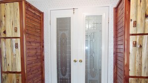 A white door with a glass panel and a brass doorknob. -  CABIN IN THE WOODS , FAMILY AND PET FRIENDLY (Warsaw)