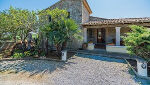 A stone building with a tiled roof, a gravel driveway, and potted plants. - MADRAVA PERICAS  Ref. VP33 (Pollensa / Pollença)