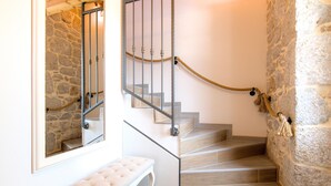 A staircase with a stone wall, a wooden bench, and a rope handrail. - Awesome home in Imotski (Imotski)