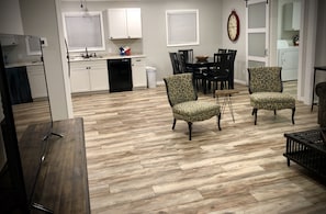 Relax in this stylish space with a dining area, comfortable armchairs, and a fully equipped kitchen.