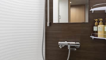 A modern bathroom with a shower, a toilet, and a vanity with a mirror and shelves for toiletries.