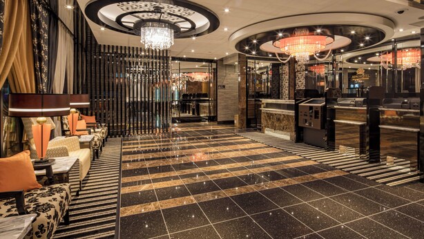A hotel lobby with a check-in counter, seating area, and a chandelier. - APA Hotel Nagoya Ekimae Kita (Nagoya)