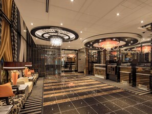A hotel lobby with a check-in counter, seating area, and a chandelier. - APA Hotel Nagoya Ekimae Kita (Nagoya)