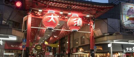 A traditional Japanese building with a red roof and lanterns.