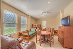 A room with a bed, a desk, a chair, a television, and a ceiling fan. - Silver Spur Rr 944016 4 Bedroom Home by RedAwning (New Braunfels)