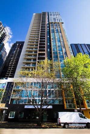 Standing tall in the city, this sleek building offers a striking contrast to the surrounding urban landscape.