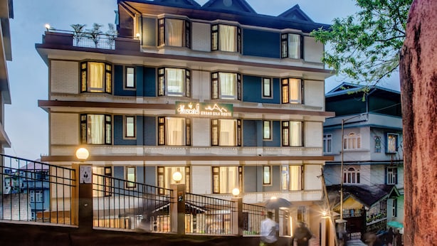 A multi-story hotel with a sign reading "Grand Silk Route." - Muscatel Grand Silk Route (Gangtok)
