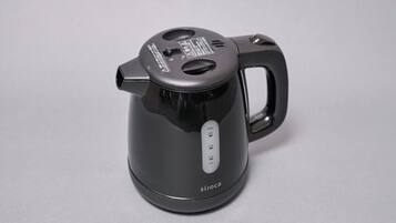 A black electric kettle with a handle and a control panel with buttons.