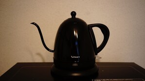 A black electric kettle on a black countertop. - Santos Heim 103 (Sapporo)