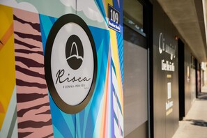 A colorful wall with a logo and text for 'Rico' and '109'.