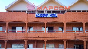 A building with a sign reading "Academia Hotel" and a logo above it. - Academia Hotel (Lomé)