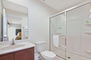 A bathroom with a white sink, toilet, and glass-enclosed shower. - Amazing Three Bedrooms w Spa/Jacuzzi close Disney @ Encantada 3012 (Kissimmee)