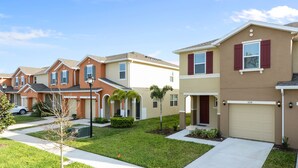 A row of townhouses with individual driveways and front yards. - Four Bedroom GameRoom Compass Bay Resort 5128A (Kissimmee)