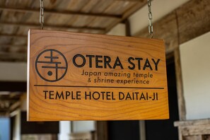 A wooden sign for Otera Stay, Temple Hotel Daidai-Ji, highlighting its Japan temple and shrine experience. - Temple Hotel Daitaiji (Nachikatsuura)
