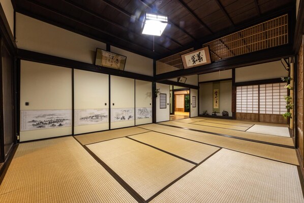 A traditional Japanese room with tatami flooring, sliding doors, and shoji screens.