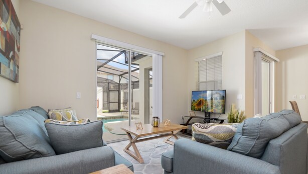 A modern living room with a sofa set, a coffee table, and a TV.