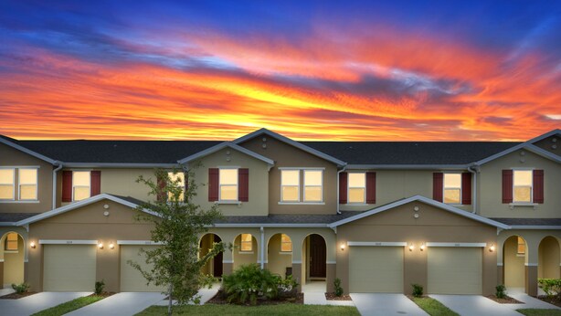 A row of townhouses with a well-maintained lawn and a sunset sky. - Family Friendly 4 Bedroom close to Disney in Compass Bay Resort 5108 (Kissimmee)