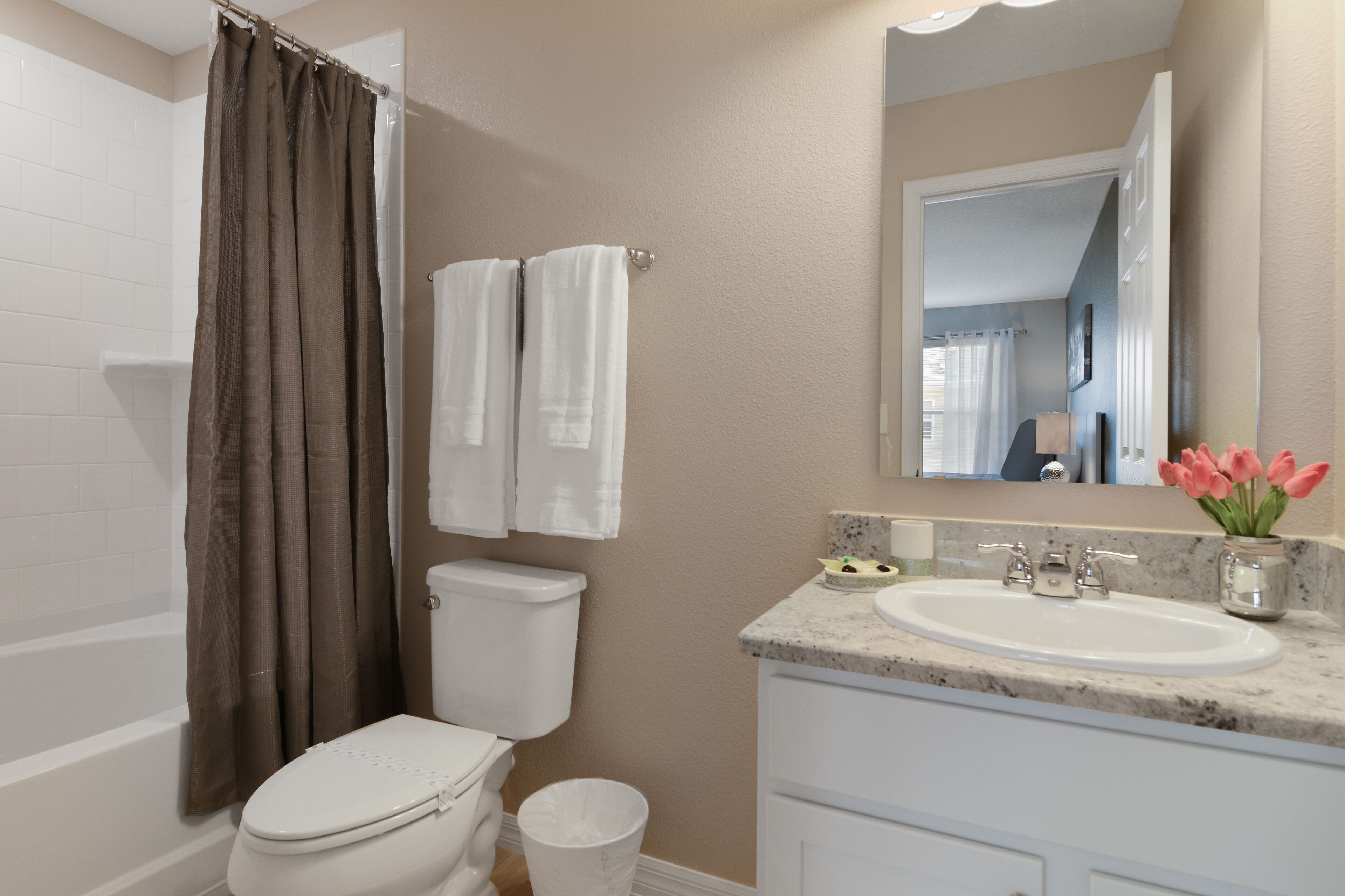 A bathroom with a toilet, sink, and bathtub.