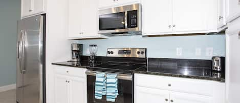 Townhome, 4 Bedrooms | Private kitchen | Full-sized fridge, microwave, oven, stovetop