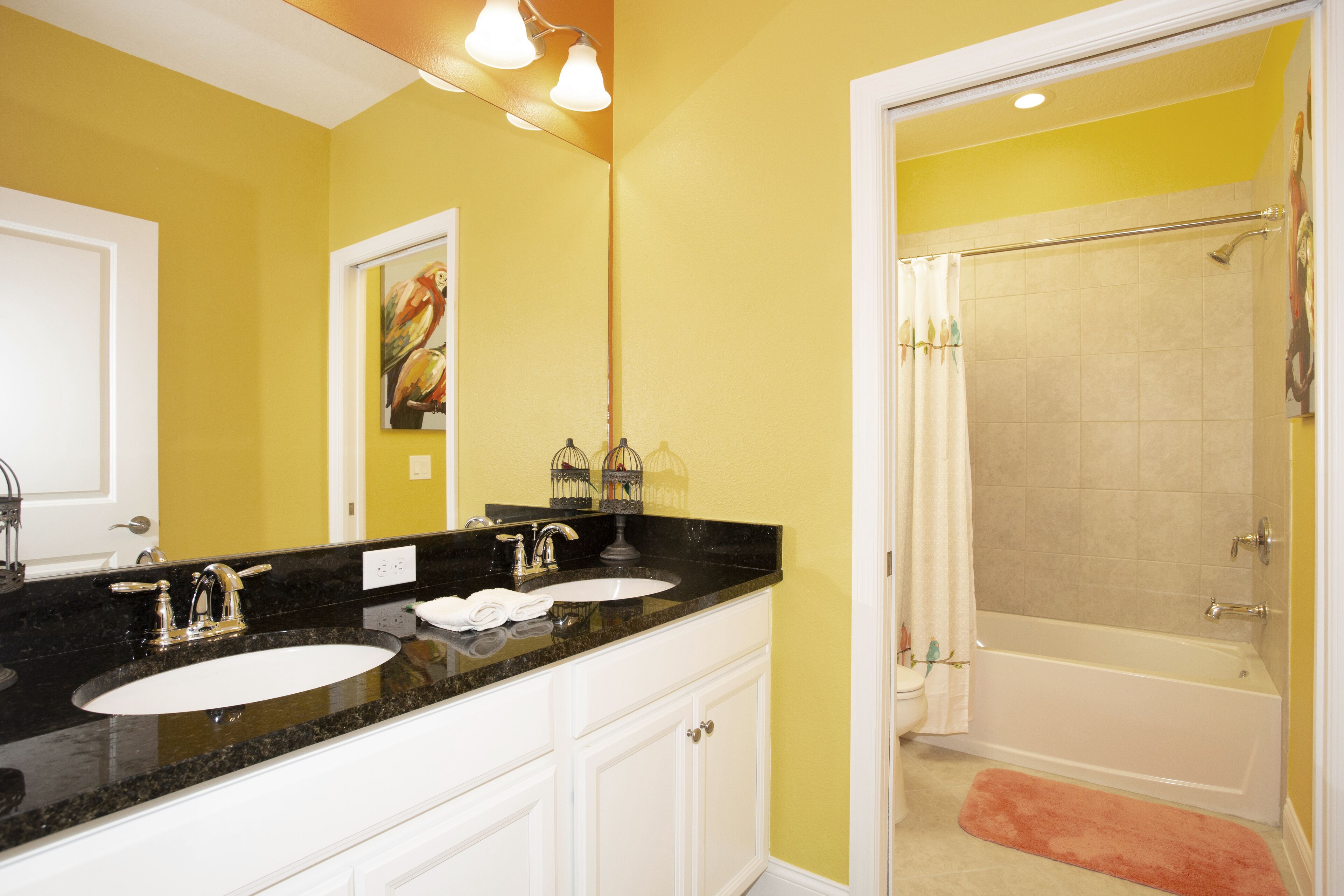 A bathroom with two sinks, a bathtub, and a shower.