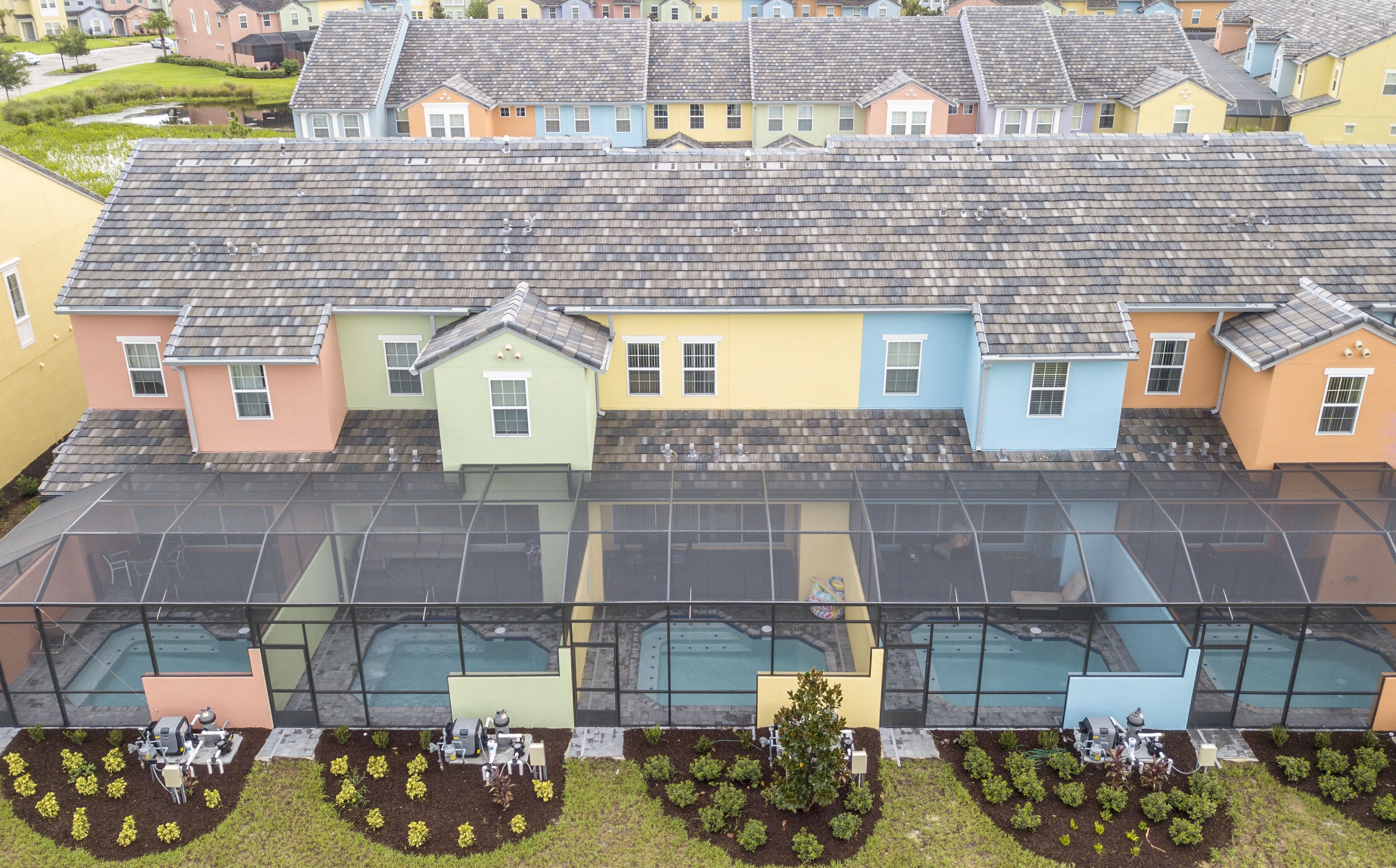 A row of colorful houses with a large glass conservatory in the foreground.