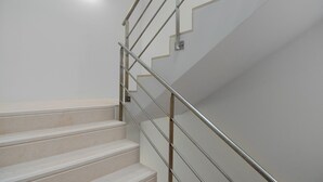 A staircase with a metal handrail and beige steps. - Cord04 Blue House Apartment 4 Parking + Super Central (Porto)