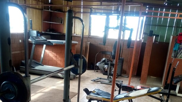 A gym with various exercise equipment, including weight machines and free weights. - Addis Lodge (Gilgil)