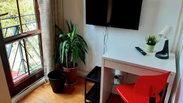 Desk, laptop workspace, blackout drapes, iron/ironing board