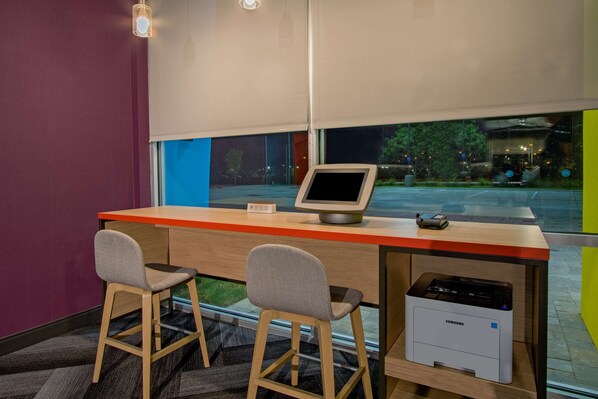 A modern office space with a desk, two chairs, a monitor, and a printer. - Tru By Hilton Waco South, TX (Waco)