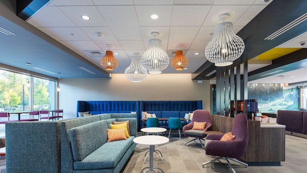 A modern lounge area with seating, tables, and decorative lighting. - Tru By Hilton Eugene, OR (Eugene)