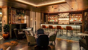 A bar area with seating and a bar counter. - The Fellows House Cambridge, Curio Collection by Hilton (Cambridge)