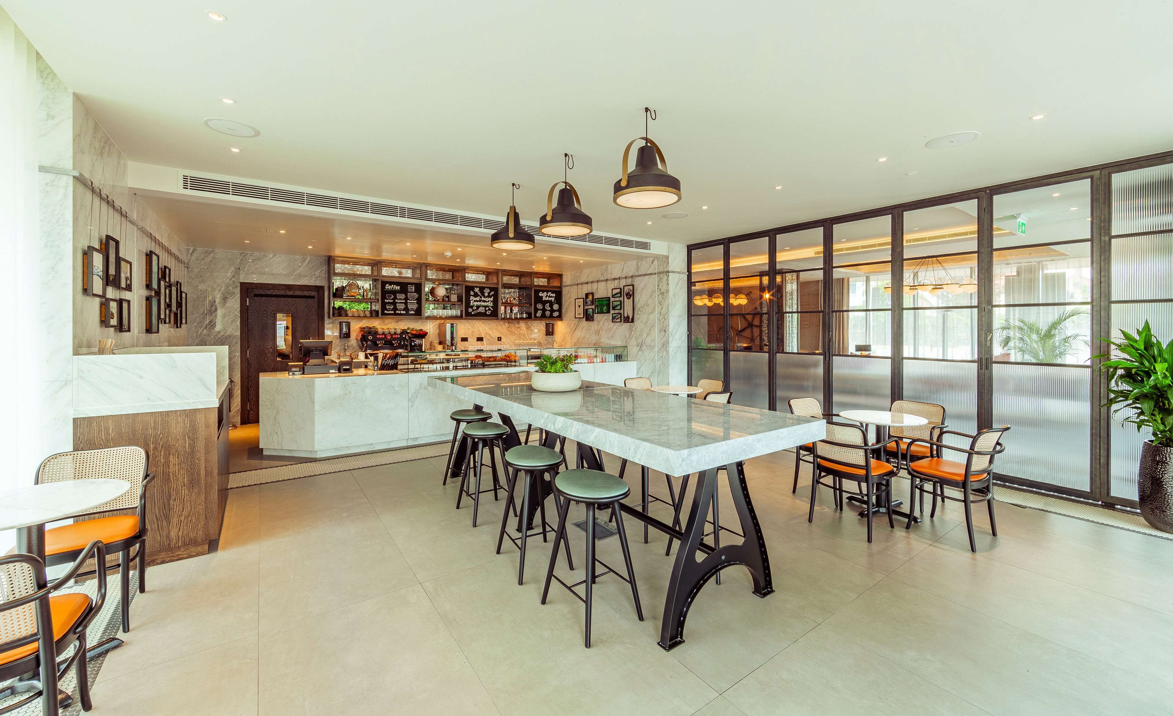 A modern kitchen with a central island, bar area, and seating.