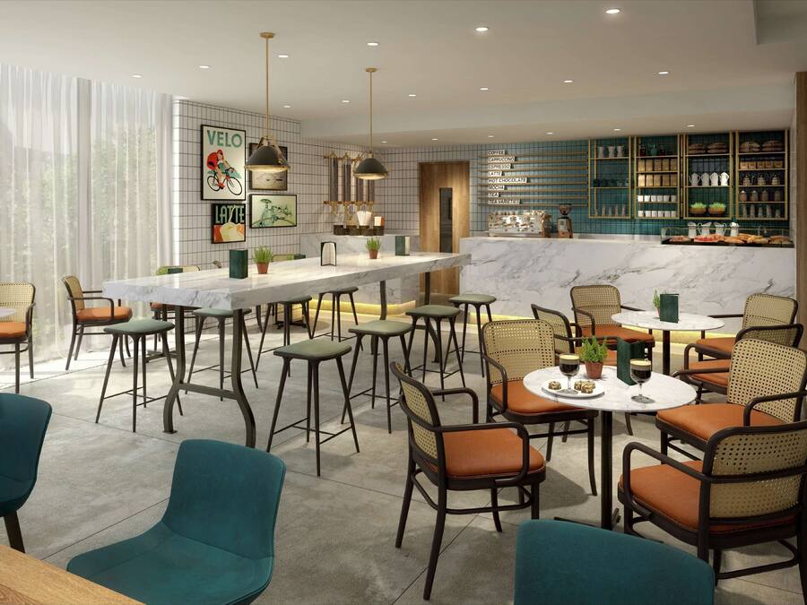 A modern cafe with a marble bar, wicker chairs, and a menu on the wall.