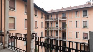 A multi-story building with balconies and windows.