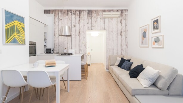 A modern apartment with a kitchen, dining area, and living room.