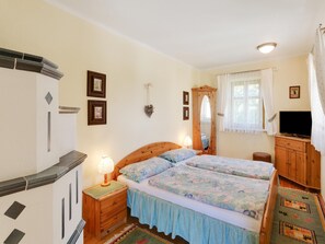 Relax in a serene bedroom with a comfortable bed, nightstand, and dresser, perfect for a restful stay.