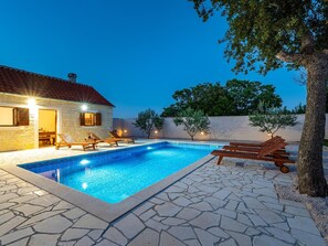 A swimming pool with lounge chairs and a stone patio. - Dalmatia Pool Villa Retreat (Stankovci)