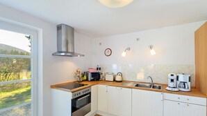 A modern kitchen with a built-in oven, microwave, and coffee maker. - Chalet in Korbach Nahe Skigebiet Willingen (Korbach)