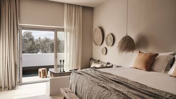 A bedroom with a large bed, a window with curtains, a view of trees, and a small wooden stool.