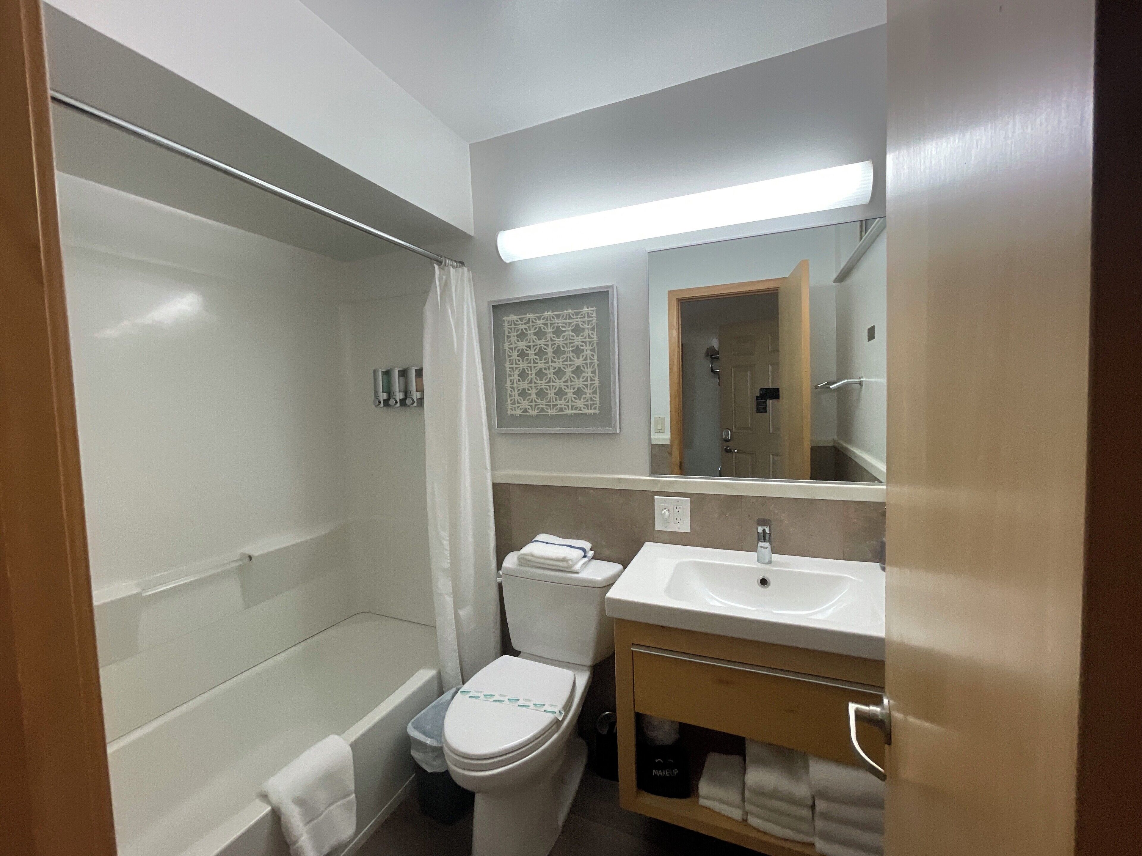 signature room, 2 queen beds, partial lake view | bathroom | combined shower/bathtub, hair dryer, towels, soap
