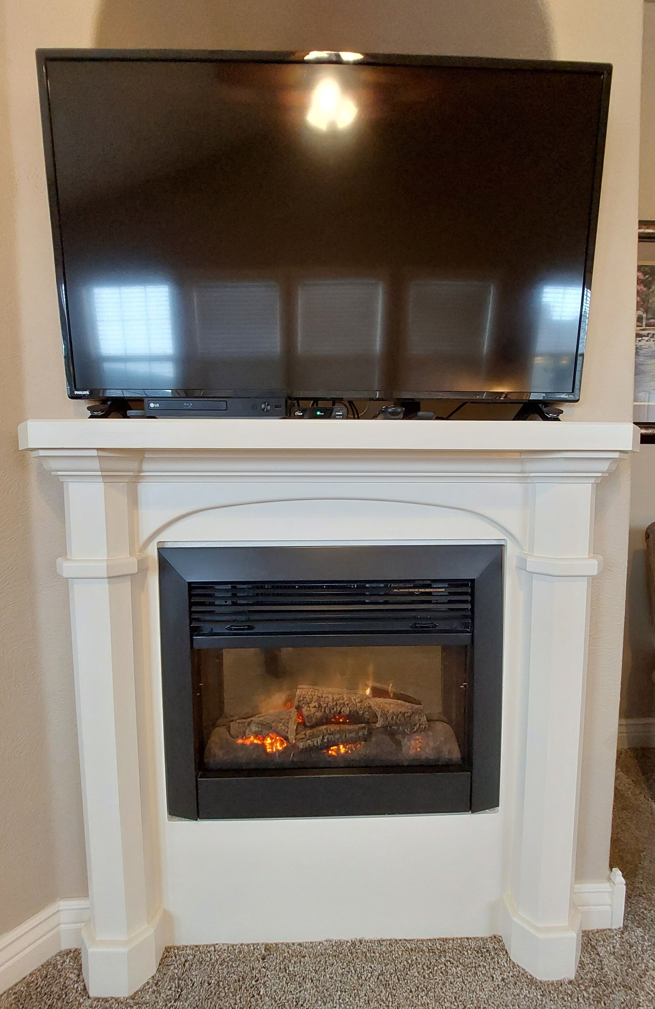 A fireplace with a TV mounted above it.